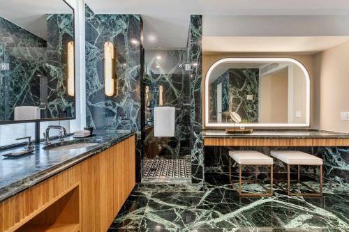 a bathroom with a sink and a mirror at Omni Las Colinas Hotel in Irving