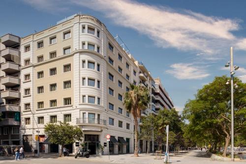 a large white building on a city street at Sercotel Amister Art Hotel Barcelona in Barcelona
