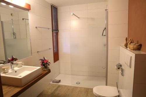 a bathroom with a sink and a shower at EcoHotel L’Aubier in Montézillon