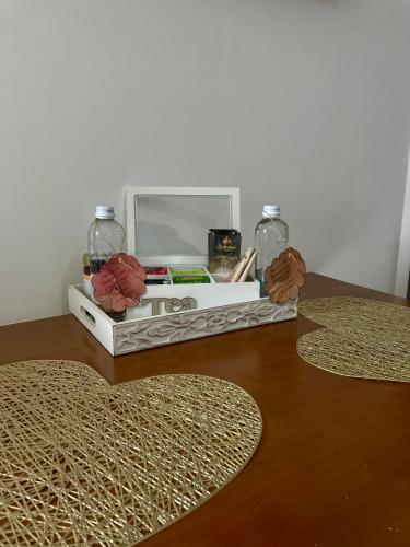 a desk with a computer and a mirror and two rugs at Апартамент Пирин in Sandanski