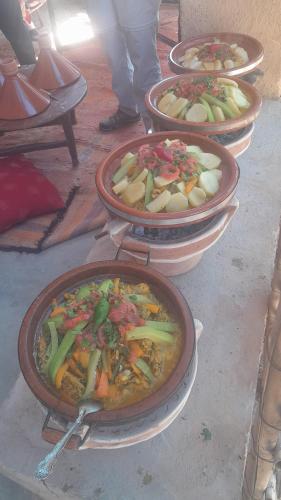 a group of bowls of food on a table at Dar Tamzdamte Skoura in Skoura