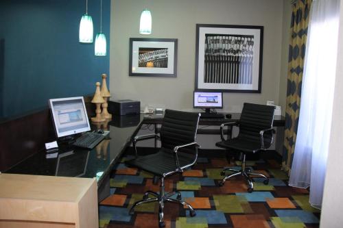 an office with a desk with two computers and chairs at Holiday Inn Express & Suites Roanoke Rapids by IHG in Roanoke Rapids