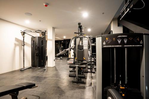 a fitness room with a gym with tread machines at Radisson San Luis Potosi Aeropuerto in Santa Ana