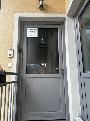 a white door to a house with a sign on it at Ferienwohnung Mölltaler Bergblick in Obervellach