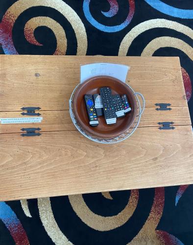 a bowl with three remote controls on a table at Our Place Up North BnB in Huntsville