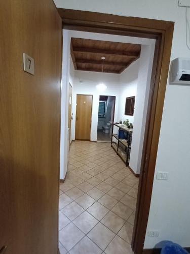a hallway of a house with a door and a tile floor at le lanterne in Foligno