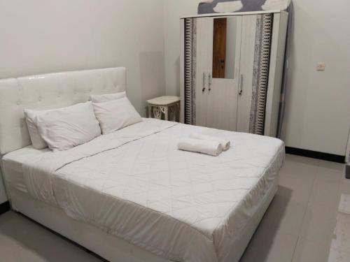 Postel nebo postele na pokoji v ubytování RUMAHKU Homestay