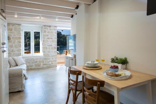a kitchen and living room with a table and chairs at E Loft in Meganisi