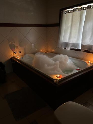 a bath tub with a cloud in it with lights at Recanto das Tirivas in Monte Verde
