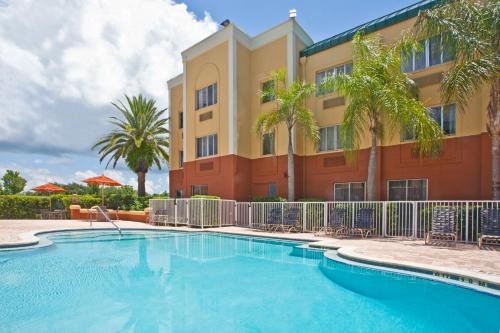 a hotel with a swimming pool in front of a building at Holiday Inn Express Hotel Clearwater East - ICOT Center by IHG in Pinellas Park