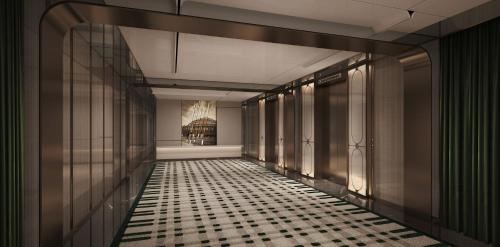 a hallway with a black and white tiled floor at Hotel Indigo Harbin Central Avenue by IHG in Harbin