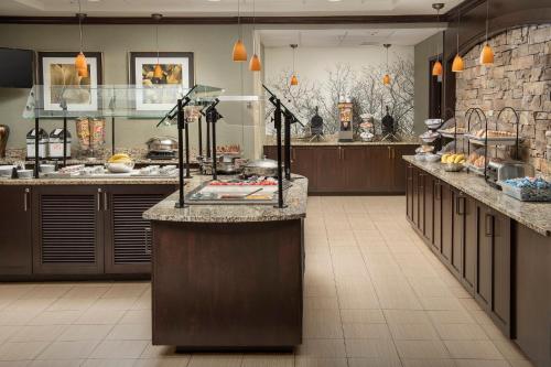 a large kitchen with a large island in a restaurant at Staybridge Suites Greenville I-85 Woodruff Road by IHG in Greenville