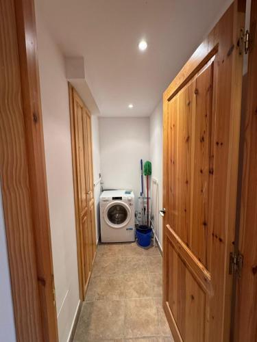 a hallway with a washer and dryer in a room at Tarter Mountain Lofts in El Tarter