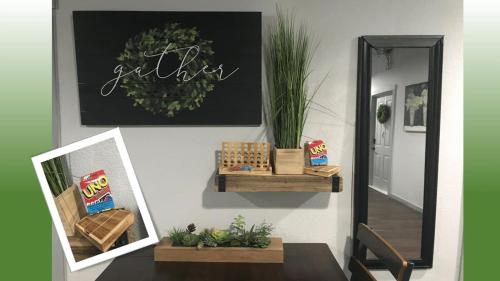 a hallway with a mirror and a table with plants at Rivers Edge Lofts - Unit 7 in Niles