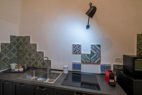 A kitchen or kitchenette at Corte dei Romiti Apartment - Lecce Selection