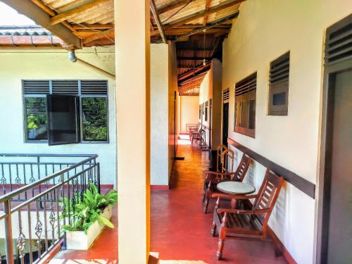 a balcony of a house with chairs and a table at Sunny Lanka Guest House in Matara