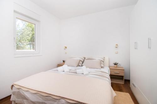 Postel nebo postele na pokoji v ubytování Apartment Ninić