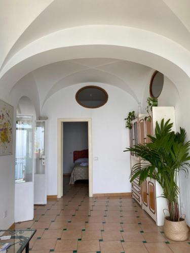 a hallway with a room with a table and a bed at Positano's Flats in Positano