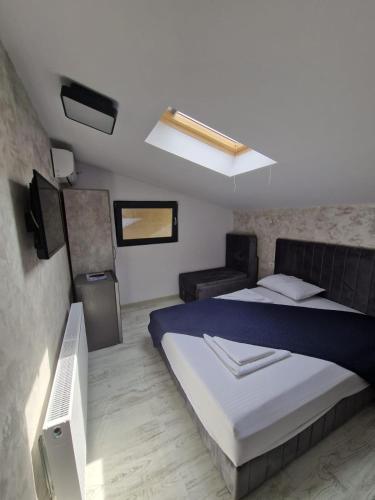 a bedroom with a bed and a flat screen tv at NeverseaBlack Sea in Constanţa