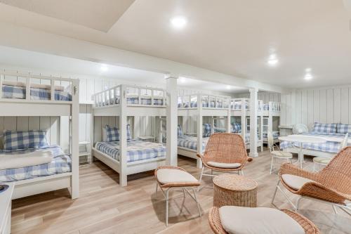 a room with four bunk beds and chairs at Walk to Lake Texoma Kingston Retreat with Deck! in Kingston