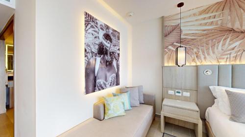 a living room with a couch and a bed at Royalton CHIC Antigua, An Autograph Collection All-Inclusive Resort - Adults Only in Saint Johnʼs