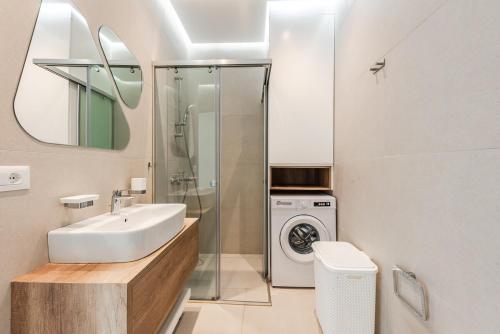Un baño con lavabo y lavadora. en Seaside Retreat Green Coast, en Himare