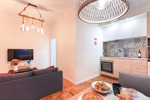 a living room with a couch and a table at Casa Do Raio City Center Ap By Sé Apartamentos in Braga
