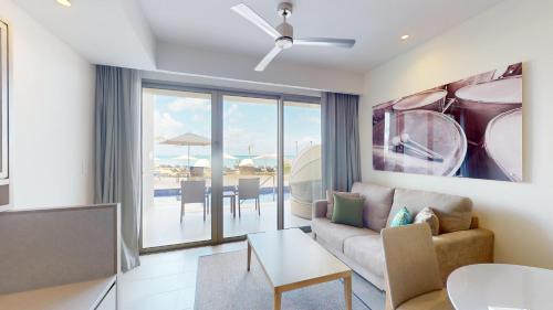 a living room with a couch and a table at Royalton CHIC Antigua, An Autograph Collection All-Inclusive Resort - Adults Only in Saint Johnʼs