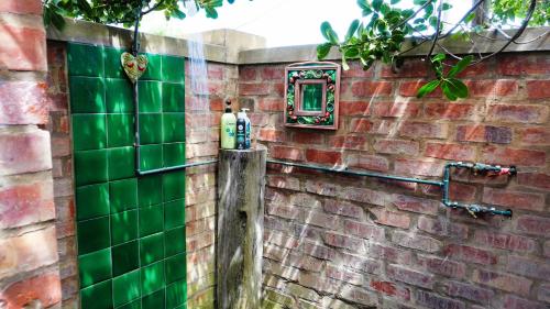 a brick wall with green tiles on it at Jubilee in Buffelsbaai