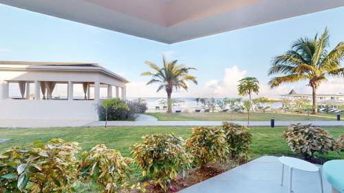 a house with a view of the beach and palm trees at Royalton CHIC Antigua, An Autograph Collection All-Inclusive Resort - Adults Only in Saint Johnʼs