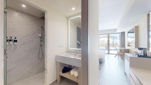 a white bathroom with a sink and a shower at Royalton CHIC Antigua, An Autograph Collection All-Inclusive Resort - Adults Only in Saint Johnʼs