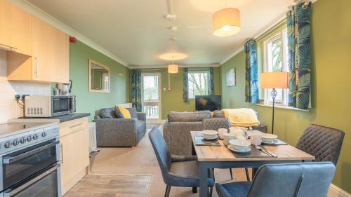 a kitchen and living room with a table and chairs at Woodclose Park in Kirkby Lonsdale