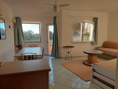 a living room with a couch and a table at Casa Mirto in Isola Rossa