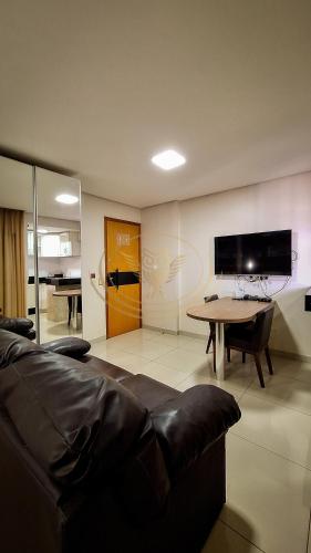 a living room with a couch and a table at Coruja Imob - Flat Crystal Place in Goiânia
