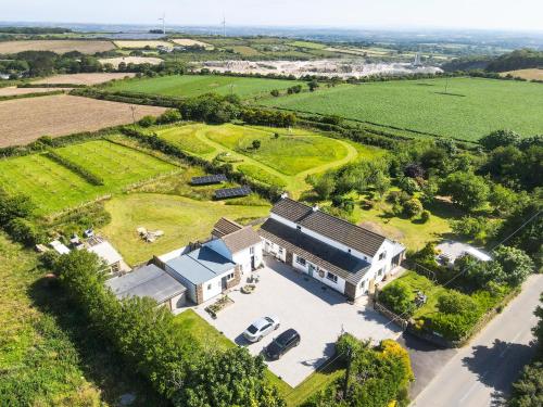 an aerial view of a house in a field at The Sty, rural retreat for couples in Falmouth