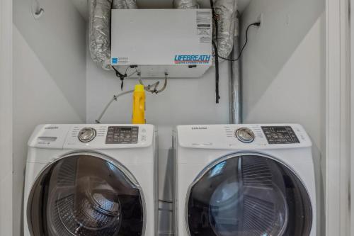 a washing machine and a dryer in a room at Fireplace Woods Club Access - Modern Quechee in Quechee