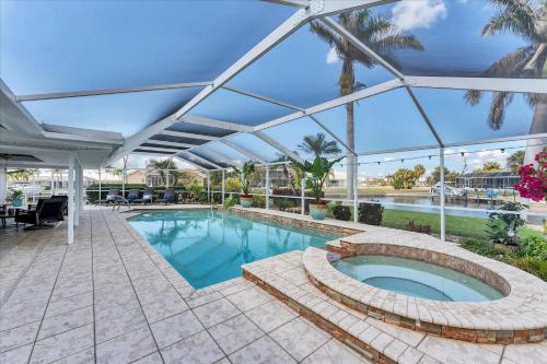 a large swimming pool with a glass roof at 803 Napoli in Punta Gorda