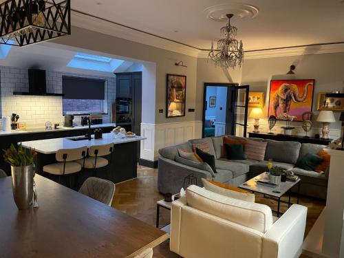 a living room with a couch and a table at East Cliff in Preston