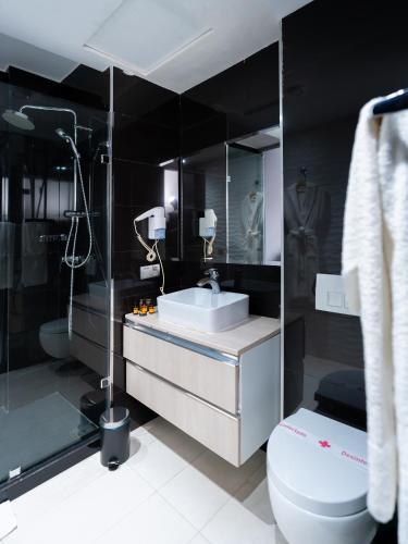 a bathroom with a sink and a toilet at The Fourteen Luxury Boutique Hotel in Casablanca
