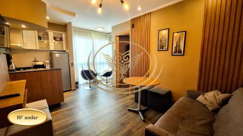 a living room with a couch and a table at Coruja Imob - Flat Crystal Place in Goiânia