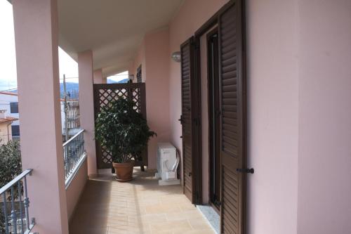 an open door to a room with a toilet on a balcony at Corallo Aparment in Cala Gonone