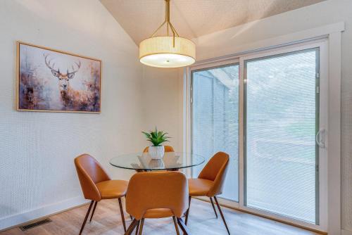 a dining room with a glass table and chairs at Pool and Marina Access Condo with Deck in Jim Thorpe in Jim Thorpe