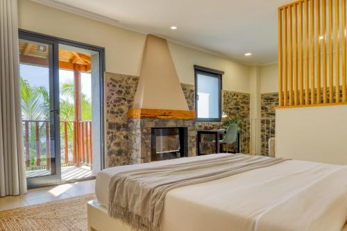 a bedroom with a bed and a fireplace at Ricardo House, a Home in Madeira in Calheta