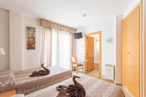 Postel nebo postele na pokoji v ubytování Hotel Cosmos Tarragona