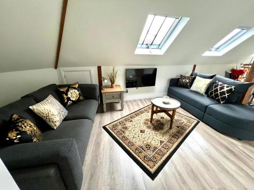 a living room with two couches and a tv at Glastonbury Secret Retreat - 1 BD Split-Level Apt, Sleeps 3 in Glastonbury