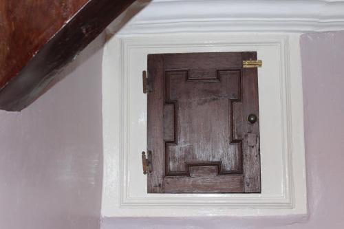 a wooden door in the corner of a room at Yallands Farmhouse in Taunton