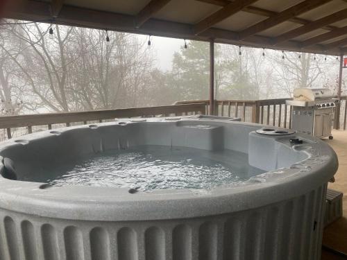 a hot tub on a deck with water in it at Chase House at Low-Key Croft - Hot-tub - Firepit in West Fork