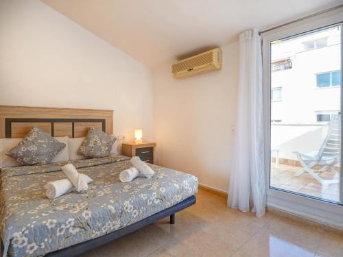 a bedroom with a bed with white pillows and a window at Ribes Duplex by Hello Homes Sitges in Sitges
