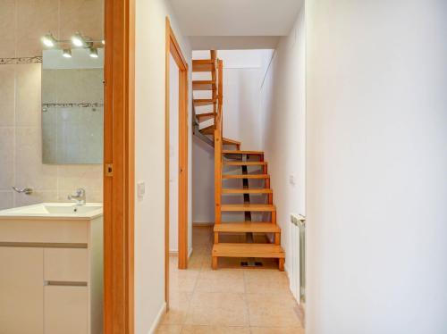 a bathroom with a staircase and a sink and a mirror at Ribes Duplex by Hello Homes Sitges in Sitges