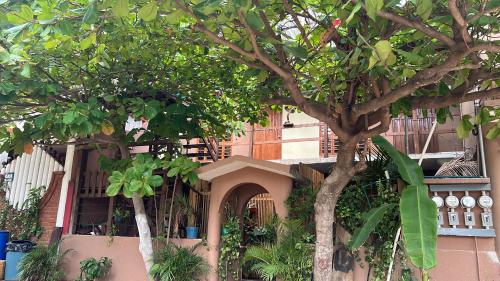a building with two trees in front of it at Casa Guiba 3 Puerto Escondido in Puerto Escondido